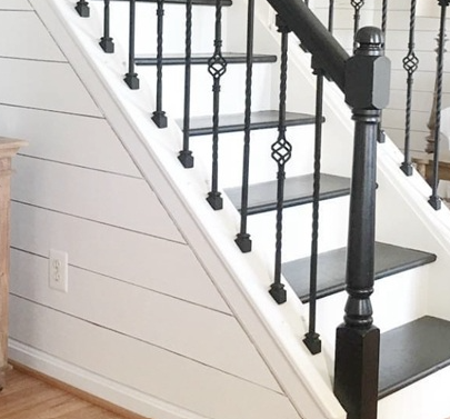 Fixed-angle brackets fitted along a pitched stair rise